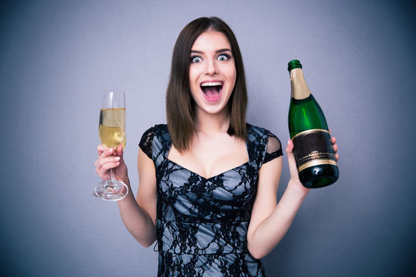 Happiness woman holding two glass and bottle of champagne - Zdjęcie, obraz