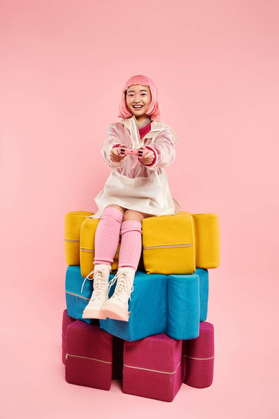cheerful asian girl with pink hair sitting on larges puzzles and playing on vibrant background - Foto, Bild