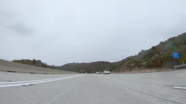 Los Angeles, California, USA-4 dicembre 2022-POV-In mezzo a una giornata invernale piovosa, guidando su HWY 134 vicino a Los Angeles, California, cattura l'atmosfera attraverso lenti coperte di pioggia, aggiungendo un unico - Filmati, video
