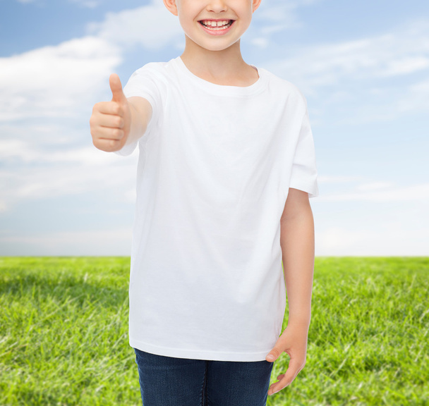 close up of boy in white t-shirt showing thumbs - Fotó, kép