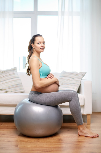 happy pregnant woman exercising on fitball at home - Foto, Imagem