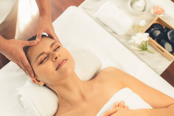 Panorama top view of woman enjoying relaxing anti-stress head massage and pampering facial beauty skin recreation leisure in dayspa modern light ambient at luxury resort or hotel spa salon. Quiescent - Photo, Image