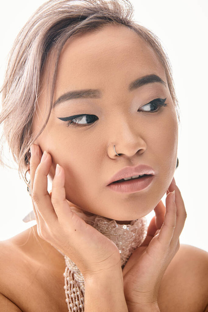 close up attractive asian young woman with elegant makeup frames around face with hands - Valokuva, kuva