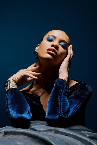 Eine junge Afroamerikanerin zeigt selbstbewusst ihr auffallend blaues Make-up. - Foto, Bild