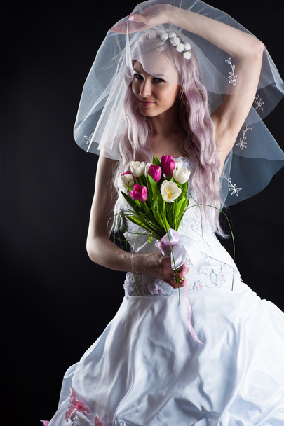 Attractive woman in a wedding dress with a veil - Фото, зображення