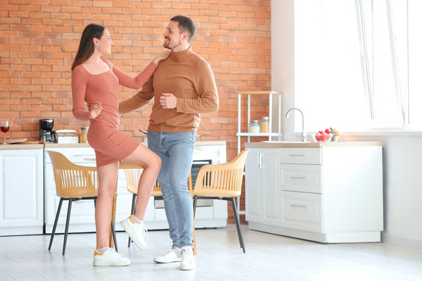 Feliz pareja joven bailando en la cocina - Foto, Imagen