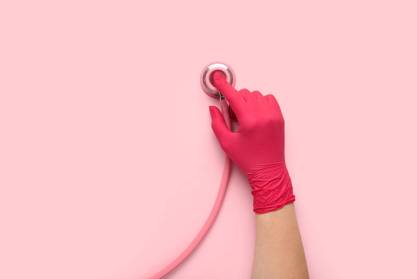 Doctor with stethoscope on pink background, top view - Photo, Image