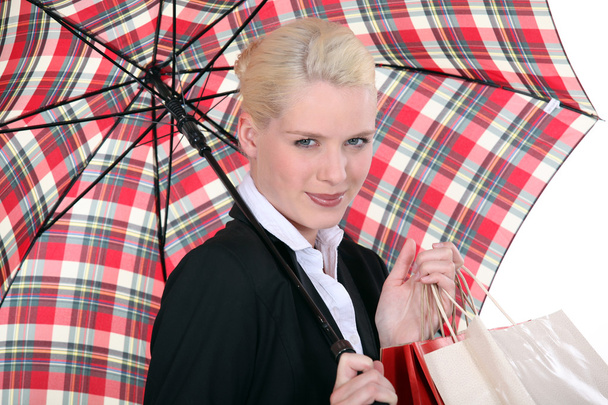 Portrait of a young woman with umbrella - 写真・画像
