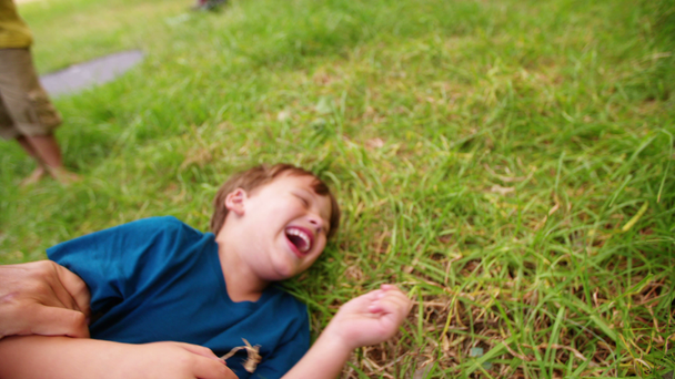 Boy laughing as he is being tickled - Footage, Video