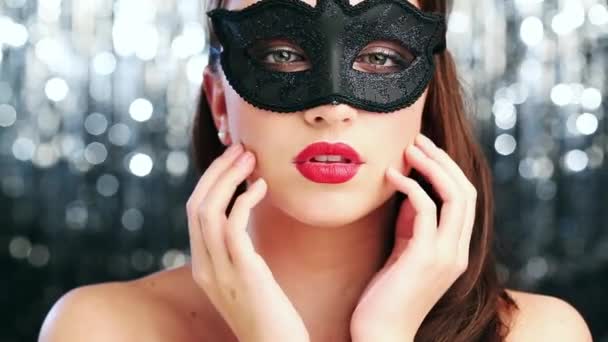 Face, ball and masquerade with woman in red lipstick on glitter background for fashion or event. Portrait, beauty and elegant young person in mask at classy party for new year celebration closeup. - Footage, Video