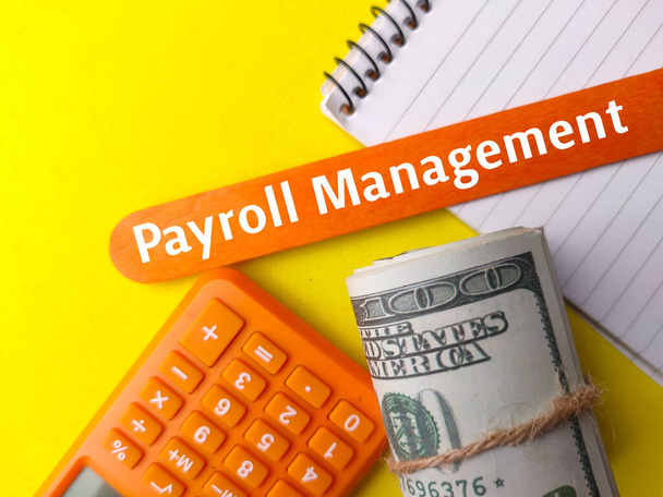 Top view calculator,banknotes and notebook with text Payroll Management on yellow background. - Photo, Image