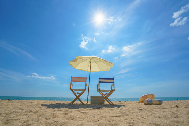 Liegestuhl und Sonnenschirm perfekt an einem ruhigen Strand platziert lädt zum Entspannen ein und fängt die Essenz der Ruhe am Meer und das Versprechen einer friedlichen Flucht ein - Foto, Bild