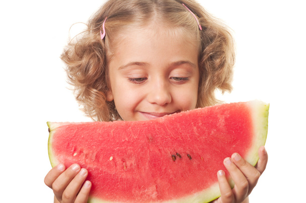 Pieni hymyilevä tyttö syö vesimelonia
 - Valokuva, kuva