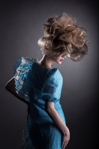 Rear view of pretty woman with creative hairstyle - Zdjęcie, obraz