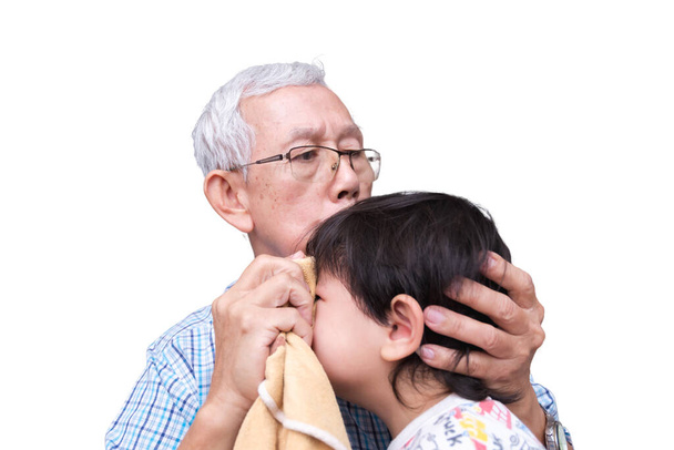 Grootvader Troostend Huilend Kind met Zorg, Een oudere man met een bril die een jong kind troost dat huilt van de pijn, die een verzorgend familiemoment voorstelt, geïsoleerd op een witte achtergrond. - Foto, afbeelding