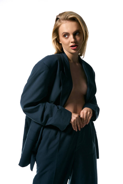 good looking sexy woman in blue unbuttoned blazer posing on white background and looking away - Valokuva, kuva