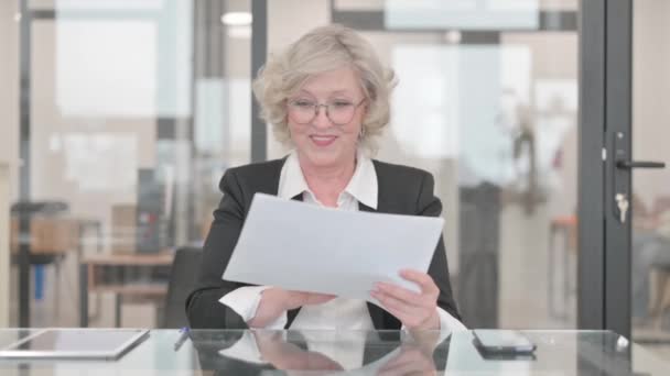 Senior Businesswoman Celebrating while Reading Documents - Footage, Video