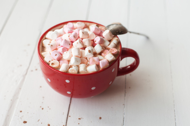 Hot chocolate with marshmallows in red cup on table - Photo, image