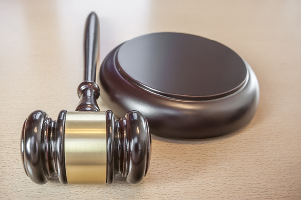 A wooden gavel on wooden table, on brown background - Photo, Image