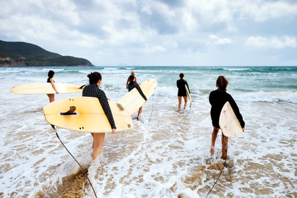 Unidentified surfers with surfing boards - Photo, Image