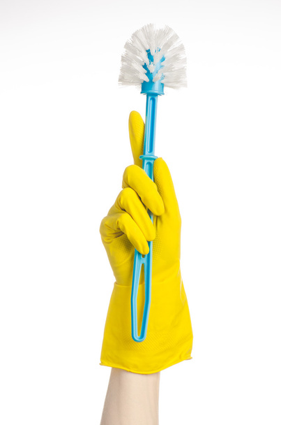 Cleaning the house and cleaning the toilet: human hand holding a blue toilet brush in yellow protective gloves isolated on a white background in studio - Foto, Imagem