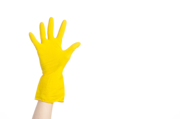 Cleaning the house and cleaning the toilet: human hand holding a blue toilet brush in yellow protective gloves isolated on a white background in studio - Fotó, kép