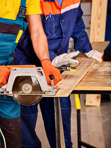 Builders with circular saw . - Photo, Image
