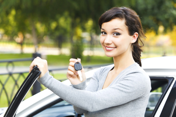 Pretty girl showing the car key - Photo, Image