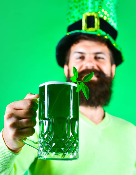 Szent Patrik nap. Szakállas férfi kobold kalapban. Lóhere sörben. Szakállas kobold. Boldog ír koboldot fekete szakállal. Szakállas ember. Szelektív fókusz - Fotó, kép