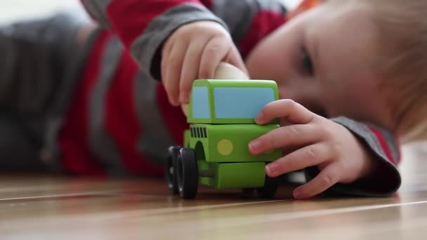 Boy playing with toy truck - Кадры, видео