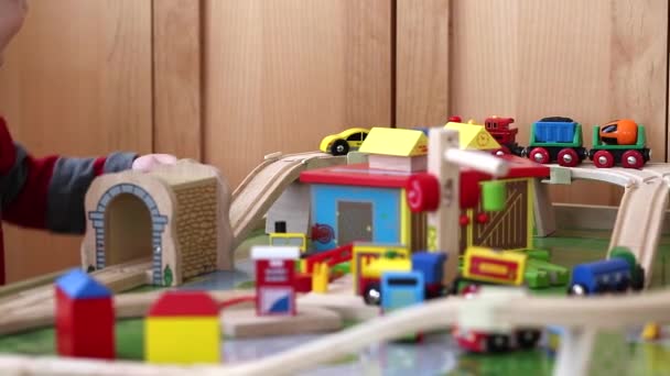Boy playing with a toy train - Materiał filmowy, wideo