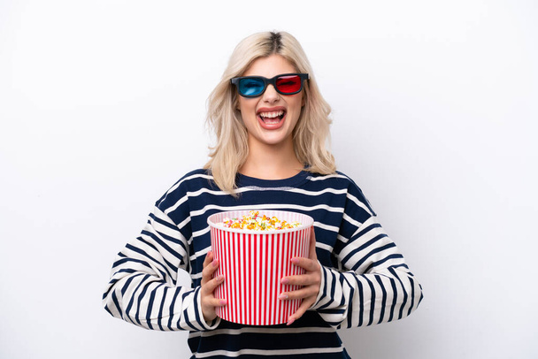 Fiatal orosz nő elszigetelt fehér háttérrel 3D-s szemüveggel és kezében egy nagy vödör popcorn - Fotó, kép