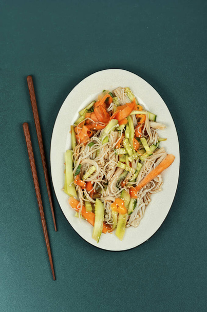 Plate with salad of enoki mushrooms and vegetables. National Chinese food. Top view. - Photo, Image