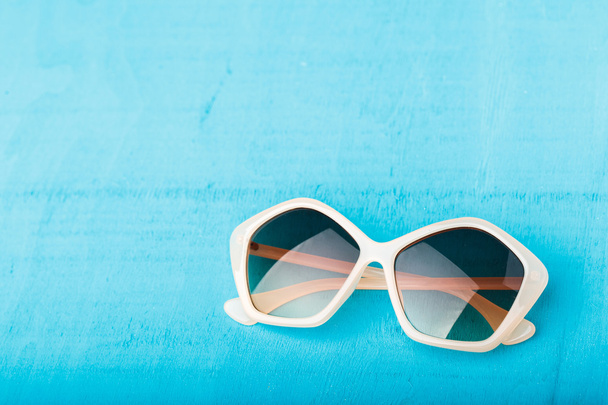 plastic sunglasses on blue - Фото, зображення