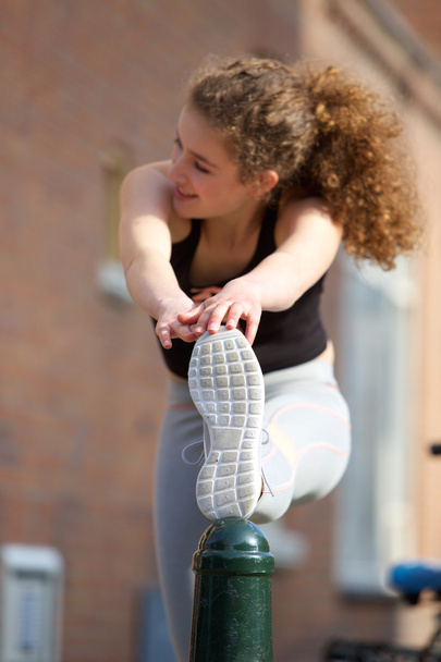 Female teenager stretching leg muscle exercise  - Фото, зображення