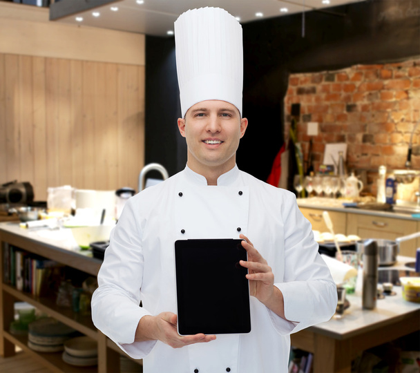 happy male chef cook showing tablet pc - Fotó, kép
