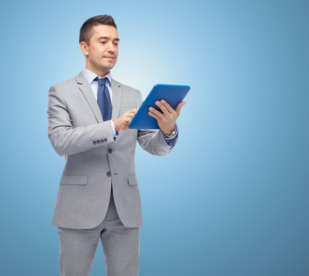 happy businessman in suit holding tablet pc - Photo, Image
