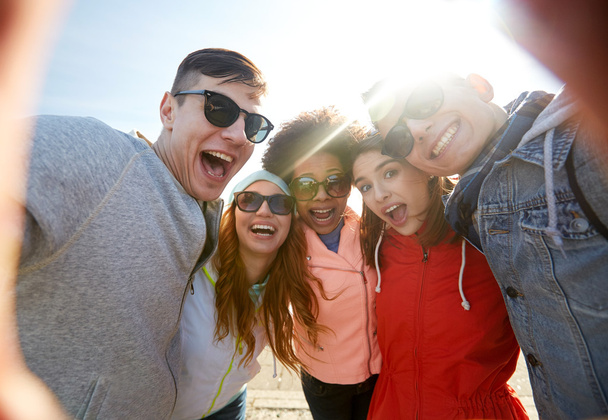happy laughing friends taking selfie - Photo, Image