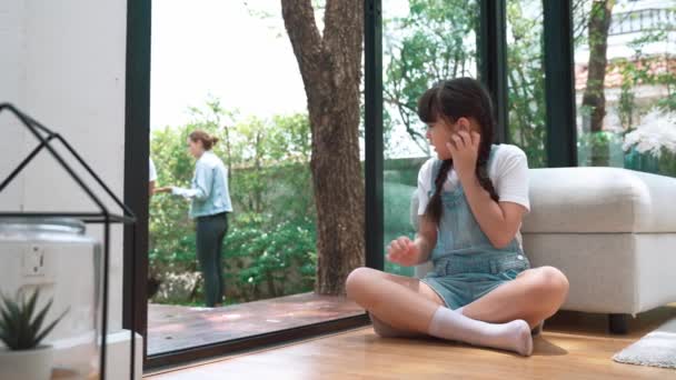 Stressed and unhappy young girl huddle in corner, cover her ears blocking sound of her parent arguing in background. Domestic violence at home and traumatic childhood develop to depression. Fastidious - Footage, Video