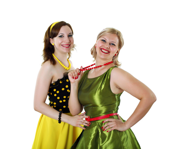 Two young woman in bright colour dresses - Photo, image
