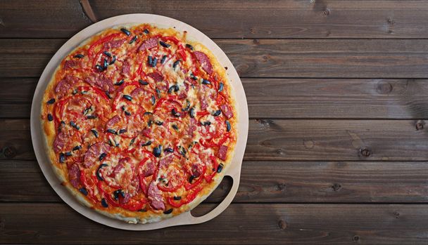 pizza on a wooden table - Photo, Image
