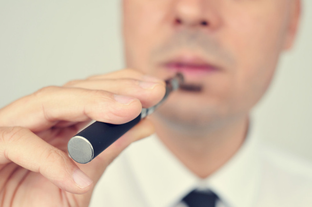 young man vaping with an electronic cigarette - Photo, Image