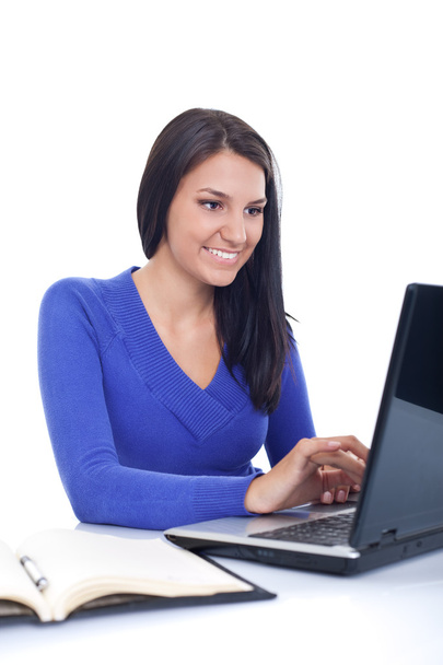 Smiling girl working on laptop - Φωτογραφία, εικόνα