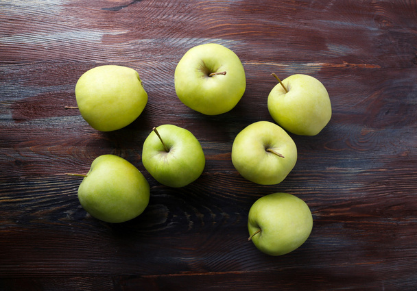 Green apples on wooden background - 写真・画像