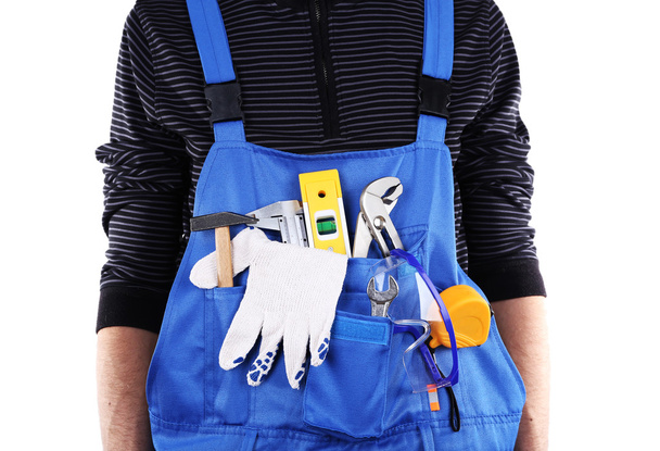 Man in coveralls with tools in his pocket isolated on white - 写真・画像