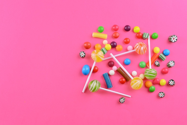 Colorful candies on pink background - 写真・画像