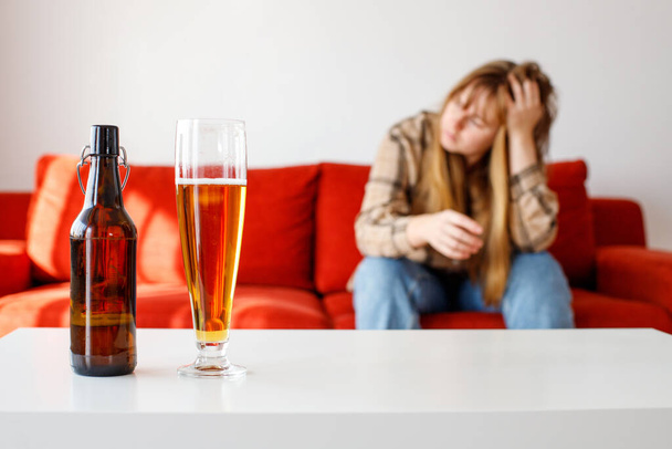 Close up woman und glass with beer having alcohol addiction, depressed female drinking alcohol suffering of personal relationships problems - Foto, imagen