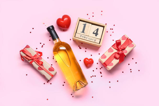 Pembe arka planda hediyeler, takvim ve dekor olan bir şişe beyaz şarap. Sevgililer Günü kutlaması - Fotoğraf, Görsel