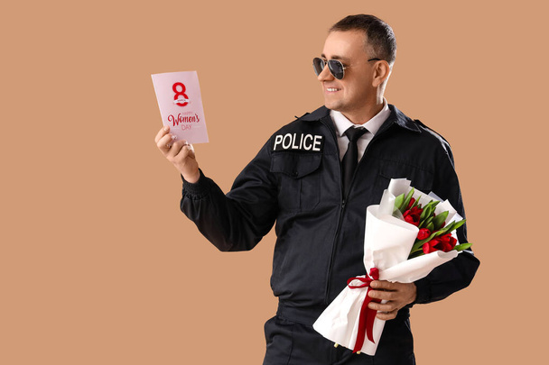 Policeman with gift card and flowers on beige background. International Women's Day - Photo, Image