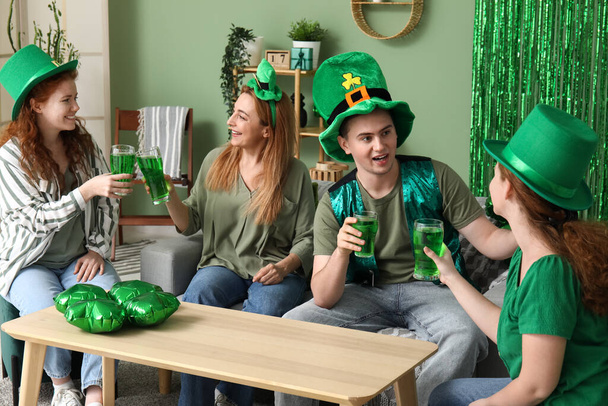 Group of people drinking beer at home on St. Patrick's Day - Photo, Image